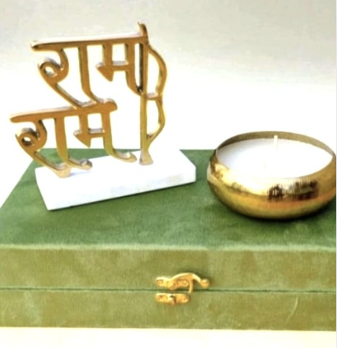 Brass-Finish Wax Urli With Ram Ram Metal Piece On A Marble Stand